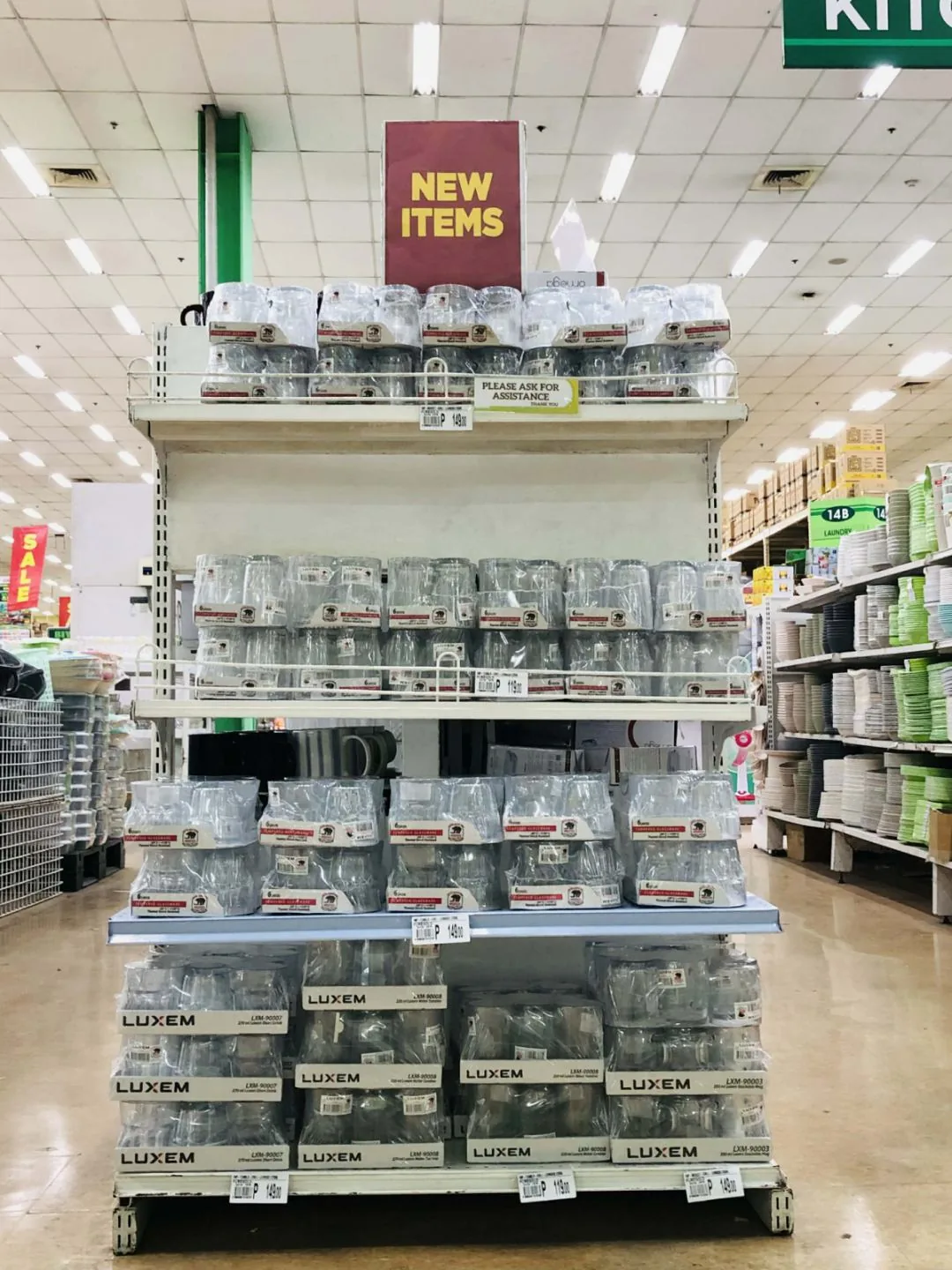 A Luxem display stand with mugs and tumblers in an aisle at Puregold